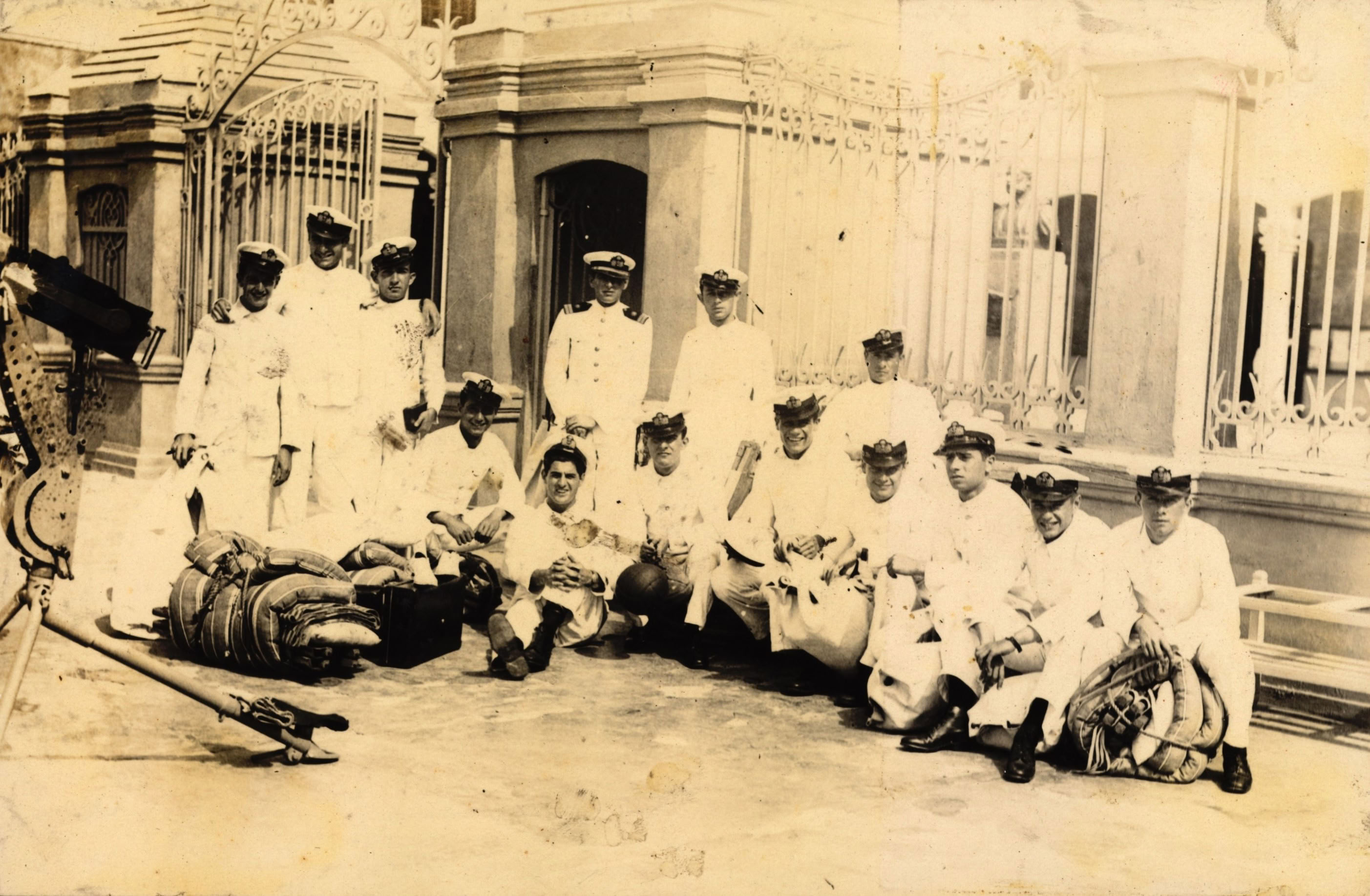 Grupo de cadetes y teniente primero en la puerta de ingreso de la Escuela Naval del Perú, c. 1935